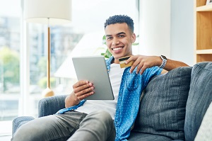 Young Man Shopping Online with Credit Card 